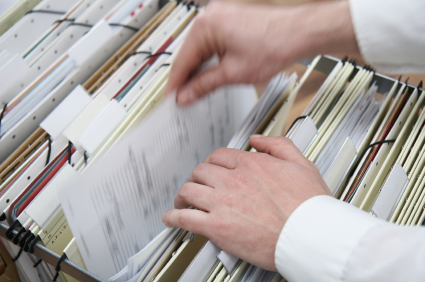 sorting through files file cabinet