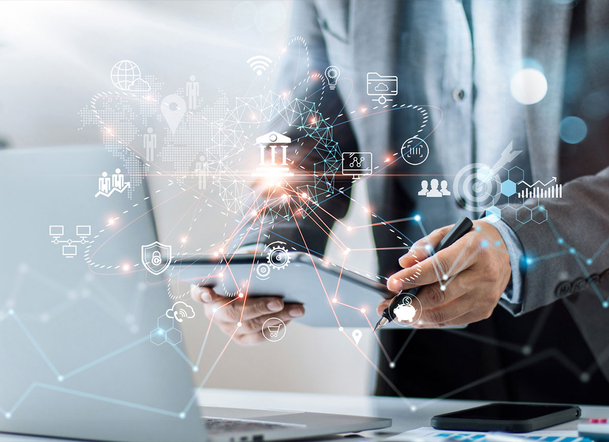 Microservices-image icons and graphics overlayed over a person holding a tablet over a laptop