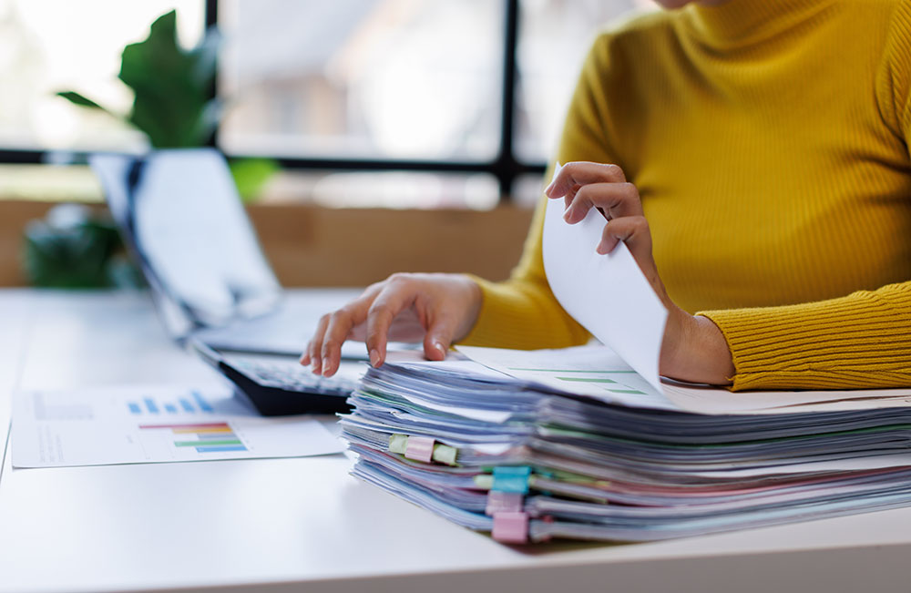 person flipping through paperwork