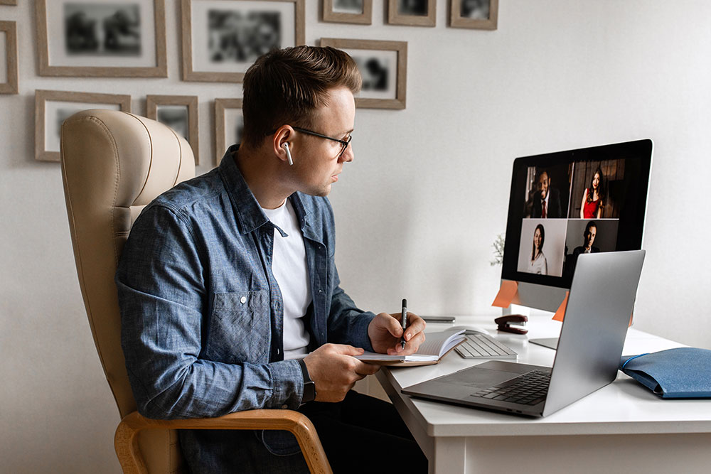 person working at desk in a conference call