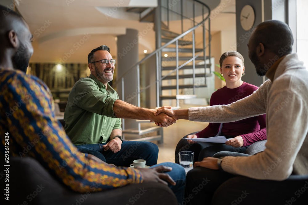 people in meeting shaking hands